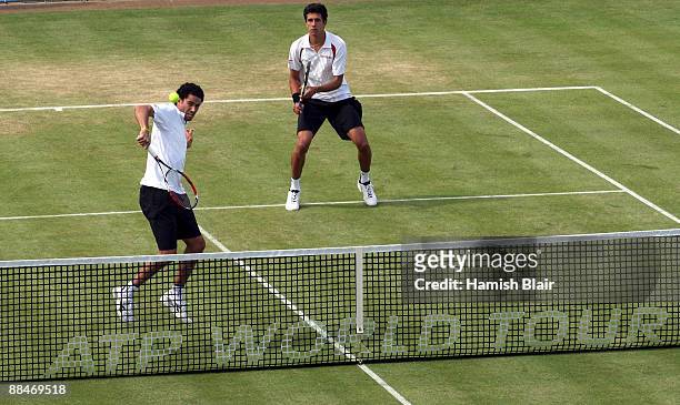 Andre Sa of Brazil plays a backhand playing with Marcelo Melo of Brazil during the men's doubles semi final match against Jeff Coetzee of South...