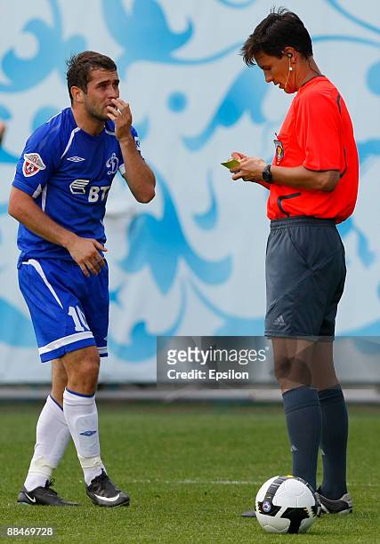 Referee, Vladimir Kazmenko shows a yellow card to Aleksandr Kerzhakov of FC Dynamo Moscow during the Russian Football League Championship match...