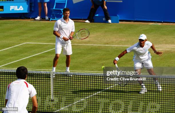 Jeff Coetzee of South Africa plays a backhand playing with Jordan Kerr of Australia during the men's doubles semi final match against Andre Sa of...