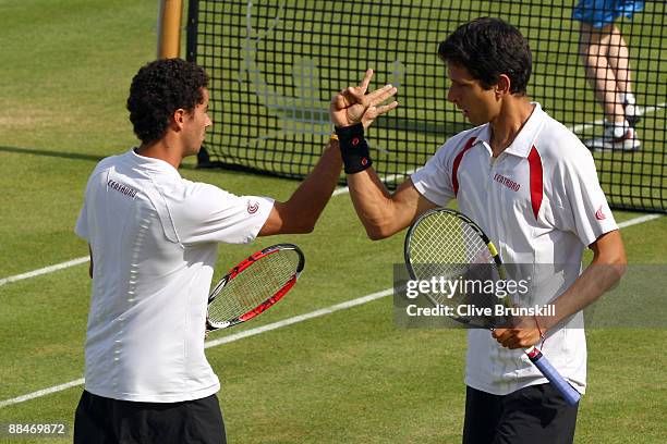 Andre Sa of Brazil talks with Marcelo Melo of Brazil during the men's doubles semi final match against Jeff Coetzee of South Africa and Jordan Kerr...