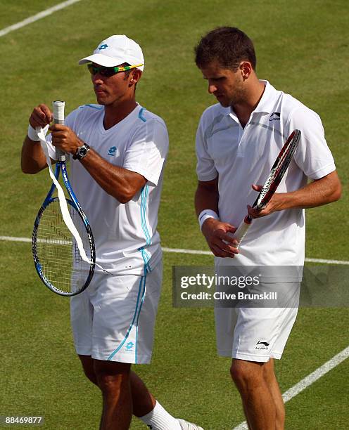 Jeff Coetzee of South Africa talks with Jordan Kerr of Australia during the men's doubles semi final match against Andre Sa of Brazil and Marcelo...