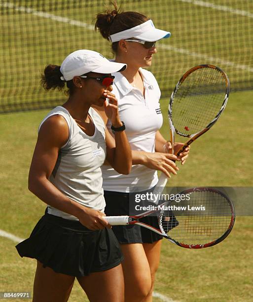 Raquel Kops-Jones and Abigail Spears of the United States in action against Francesca Schiavone and Roberta Vinci of Italy during day Six of the...