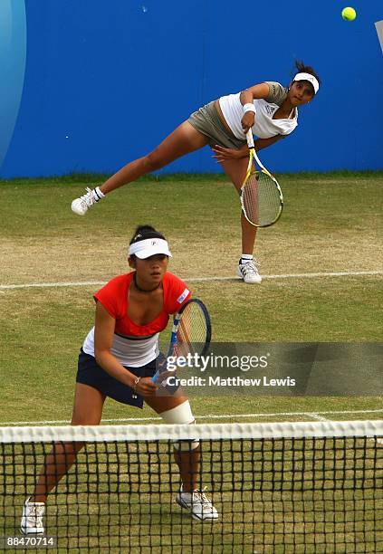 Sania Mirza of India and Chia-Jung Chuang of Taiwan in action against Liezel Huber of the United States and Cara Black of Zimbabwe during day Six of...