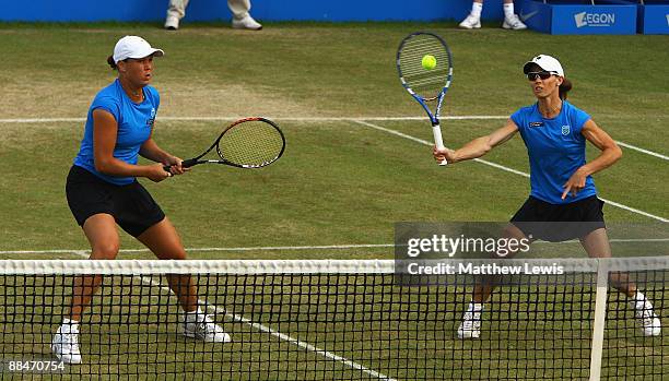 Liezel Huber of the United States and Cara Black of Zimbabwe in action against Sania Mirza of India and Chia-Jung Chuang of Taiwan during day Six of...