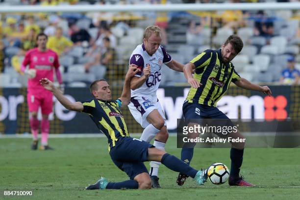Alan Baro of the Mariners contests the ball against Mitch Nichols of Perth Glory with Antony Golec of the Mariners during the round nine A-League...