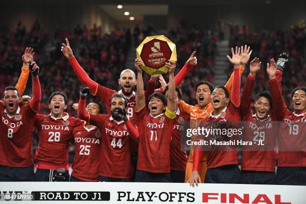 Captain Hisato Sato of Nagoya Grampus lifts the trophy as they celebrate the promotion to the J1 after the J.League J1 Promotion Play-Off Final...