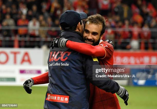 Gabriel Xavier of Nagoya Grampus is congratulated by head coach Yahiro Kazama during the J.League J1 Promotion Play-Off Final between Nagoya Grampus...