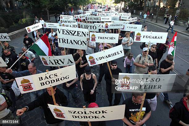 Activists and sympathizers of the nacionalist "64 Counties Youth Movement" hold some counties' name of former Hungary as they march together to the...