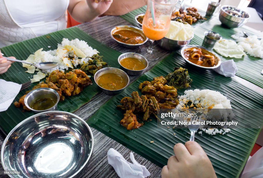 Group of People Eating Sadya or Banana Leaf Rice Indian Food.