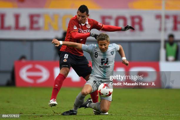 Riki Matsuda of Avispa Fukuoka controls the ball under pressure of Washington of Nagoya Grampus during the J.League J1 Promotion Play-Off Final...