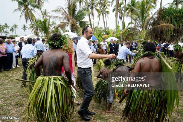 French Prime Minister Edouard Philippe dances as he takes part in a welcoming ceremony at the Case de la Grande Chefferie de Gaica to meet residents...