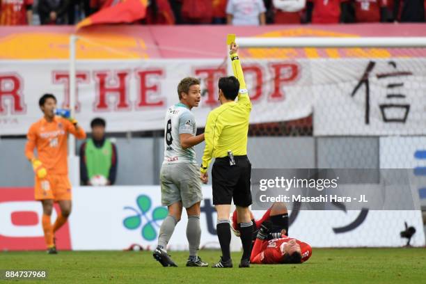 Riki Matsuda of Avispa Fukuoka is shown a yellow card by referee Hiroyuki Kimura during the J.League J1 Promotion Play-Off Final between Nagoya...