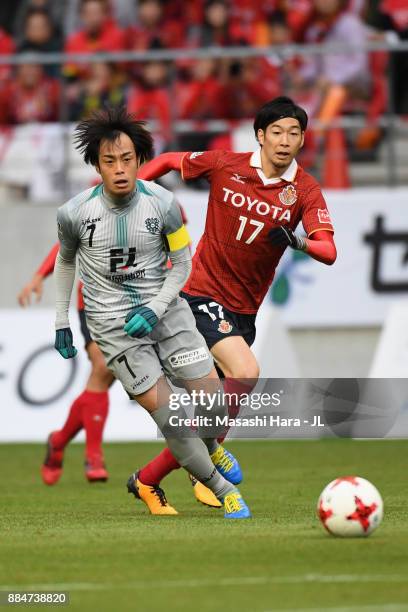 Yuta Mikado of Avispa Fukuoka and Yuki Kobayashi of Nagoya Grampus compete for the ball during the J.League J1 Promotion Play-Off Final between...