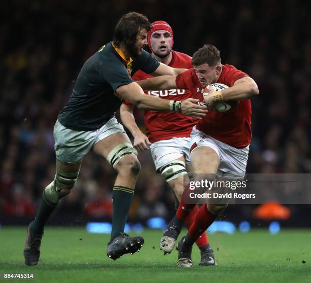 Elliot Dee of Wales is held by Lood de Jager during the rugby union international match between Wales and South Africa at the Principality Stadium on...