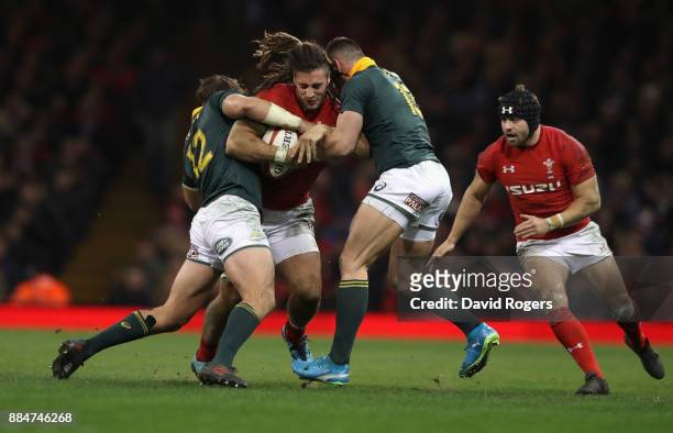 Josh Navidi of Wales is tackled by Francois Venter and Jesse Kriel during the rugby union international match between Wales and South Africa at the...