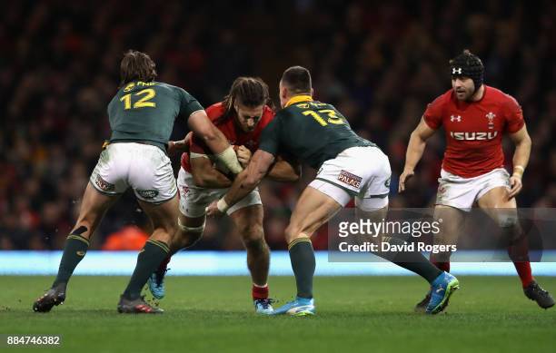 Josh Navidi of Wales is tackled by Francois Venter and Jesse Kriel during the rugby union international match between Wales and South Africa at the...
