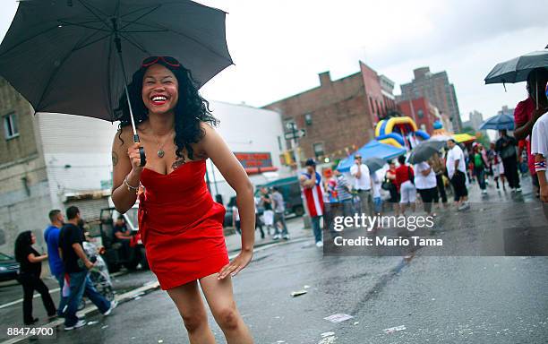 Natasha Velez celebrates during the 116th Street Festival in Spanish Harlem June 13, 2009 in New York City. The 28-block festival draws around...