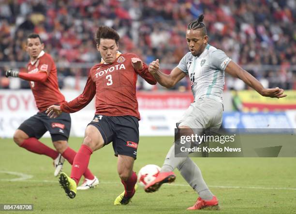 Willington of Avispa Fukuoka shoots as Kazuki Kushibiki of Nagoya Grampus rushes to block in the first half of a 0-0 draw in the J-League second...