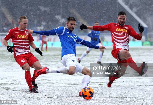 Tobias Kempe of Darmstadt and Alexander Nandzik and Benedikt Gimber of Regensburg battle for the ball during the Second Bundesliga match between SV...