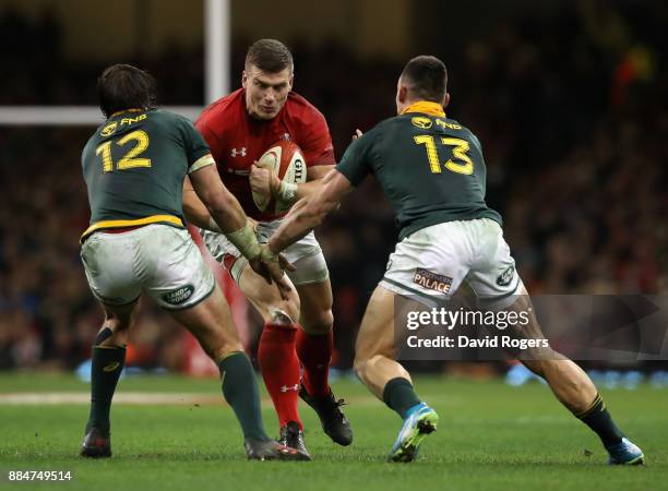 Scott Williams of Wales is tackled by Francois Venter and Jesse Kriel during the rugby union international match between Wales and South Africa at...