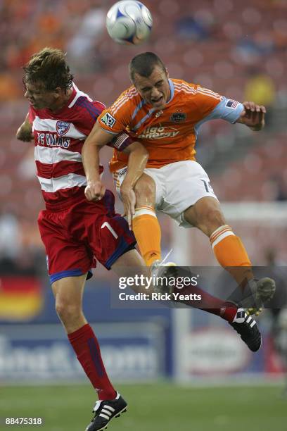 Cam Weaver of the Houston Dynamo wins the header against Dave van den Bergh of the FC Dallas at Pizza Hut Park on June 13, 2009 in Frisco, Texas.