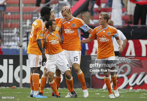 Kei Kamara, Brian Mullen, Andrew Hainault and Stuart Holden of the Houston Dynamo congratulate teammate Cam Weaver on his goal against FC Dallas at...