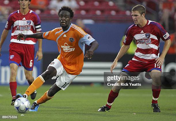 Kei Kamara of the Houston Dynamo dribbles the ball around Kyle Davies of the FC Dallas at Pizza Hut Park on June 13, 2009 in Frisco, Texas.