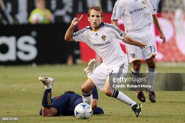 Mike Magee of the Los Angeles Galaxy wins a loose ball against the defense of Real Salt Lake during their MLS game at The Home Depot Center on June...