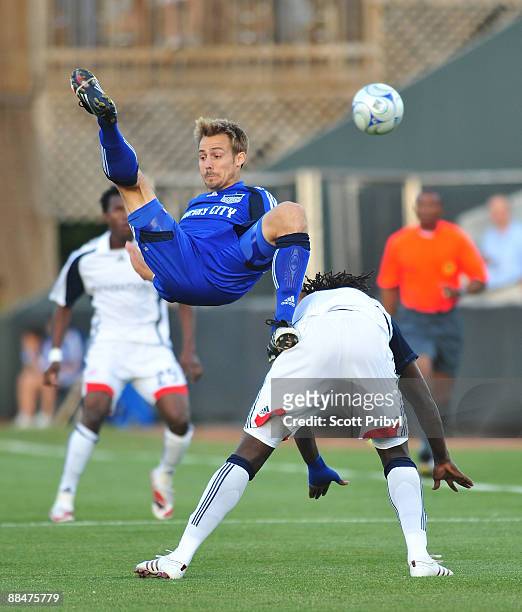 Jack Jewsbury goes upside down fighting Shalrie Joseph for the ball during the New England Revolution game against Kansas City Wizards at Community...