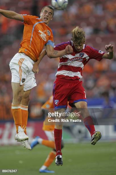 Cam Weaver of the Houston Dynamo heads the ball above Dave van den Bergh of the FC Dallas at Pizza Hut Park on June 13, 2009 in Frisco, Texas.