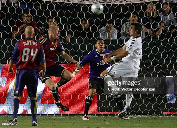 Goalkeeper Nick Rimando and Nat Borchers of Real Salt Lake defends their net as Alan Gordon of the Los Angeles Galaxy waits to head the ball on goal...