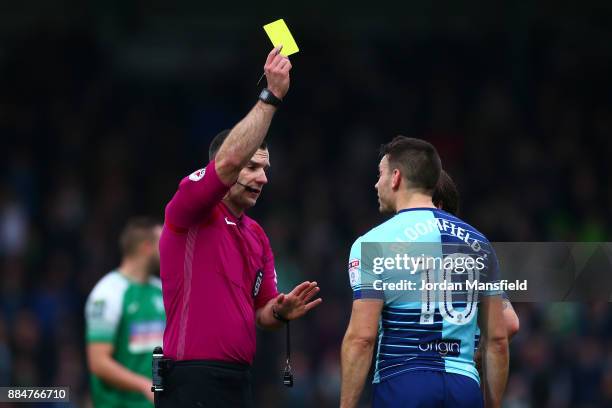 Matt Bloomfield of Wycombe Wanderers is shown a yellow card by referee Tim Robinson during The Emirates FA Cup Second Round between Wycombe Wanderers...