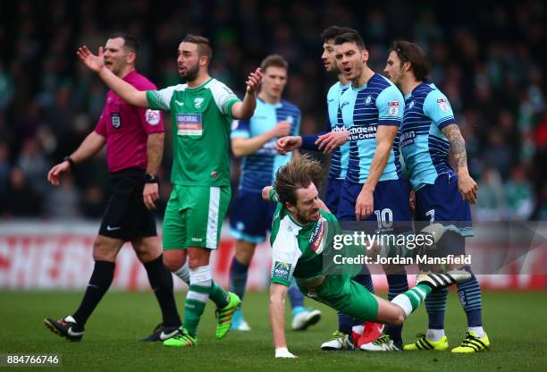 Matt Bloomfield of Wycombe Wanderers and Jack Midson of Letherhead clash during The Emirates FA Cup Second Round between Wycombe Wanderers and...