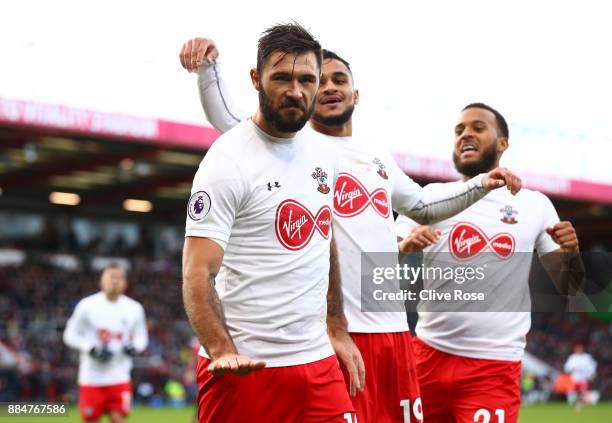 Charlie Austin of Southampton celebrates after scoring his sides first goal with Sofiane Boufal of Southampton and Ryan Bertrand of Southampton...