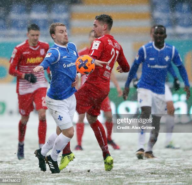 Fabian Holland of Darmstadt is challenged by Kevin Hoffmann of Regensburg during the Second Bundesliga match between SV Darmstadt 98 and SSV Jahn...
