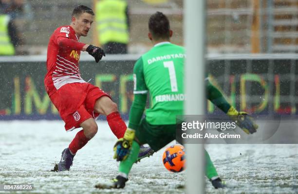 Sebastian Stolze of Regensburg tries to score against goalkeeper Daniel Heuer Fernandes of Darmstadt during the Second Bundesliga match between SV...