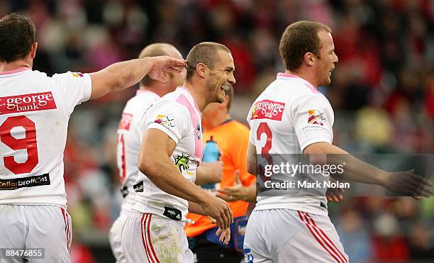 Matt Cooper of the Dragons is congratulated after scoring a try during the round 14 NRL match between the St George Illawarra Dragons and the North...