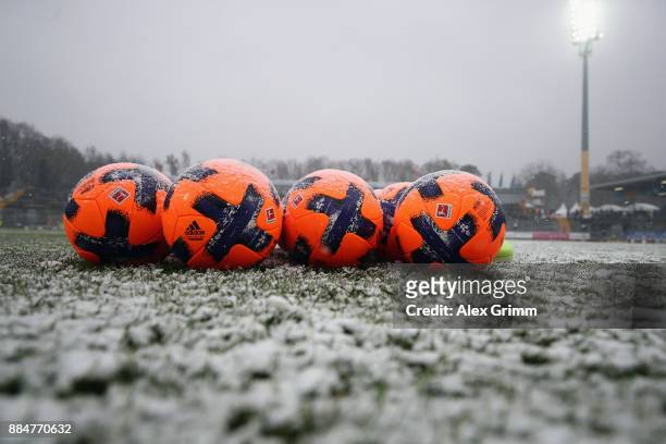 Official adidas matchballs Torfabrik are seen on the snow covered pitch prior to the Second Bundesliga match between SV Darmstadt 98 and SSV Jahn...