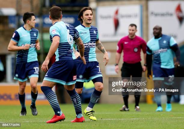 Wycombe Wanderers' Sam Saunders is congratulated by team mate Adam El-Abd after scoring his side's first goal during the Emirates FA Cup, second...