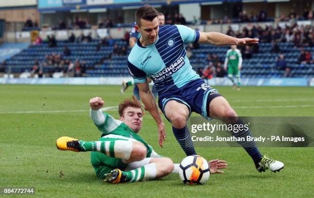 Leatherhead's Sam Blackman tackles Wycombe Wanderers' Matt Bloomfield during the Emirates FA Cup, second round match at Adams Park, Wycombe.