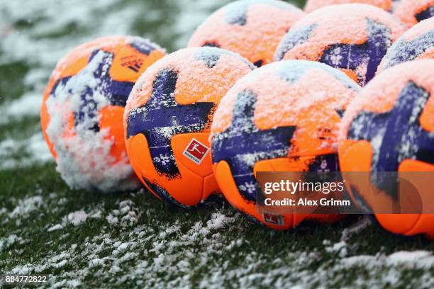 Official adidas matchballs Torfabrik are seen on the snow covered pitch prior to the Second Bundesliga match between SV Darmstadt 98 and SSV Jahn...