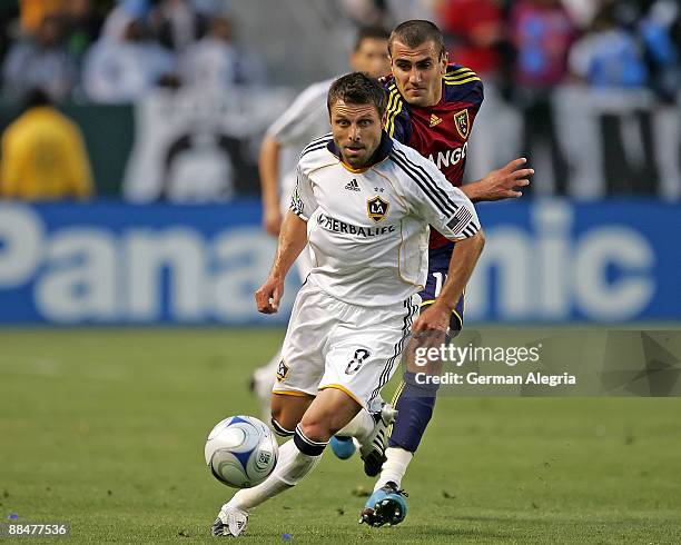 Dema Kovalenko of the Los Angeles Galaxy controls the ball against Yura Movsisyan of Real Salt Lake during their MLS game at The Home Depot Center on...