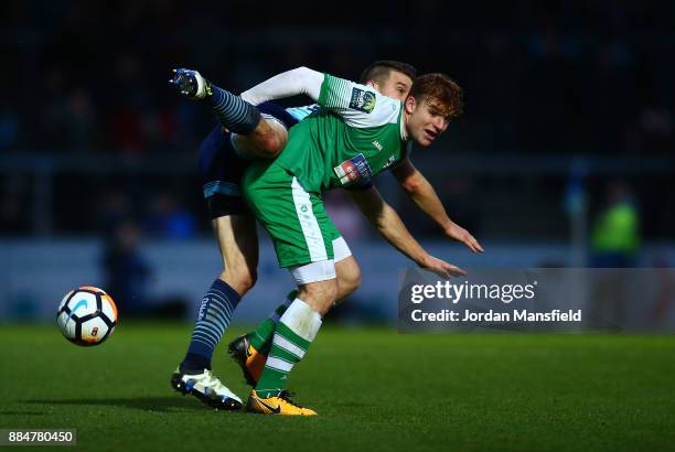 Matt Bloomfield of Wycombe Wanderers challenges Sam Blackman of Letherhead during The Emirates FA Cup Second Round between Wycombe Wanderers and...