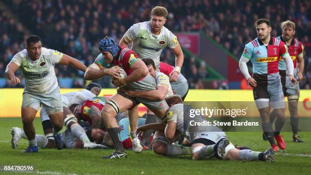 James Horwill of Harlequins is tackled by the Saracens defence during the Aviva Premiership match between Harlequins and Saracens at Twickenham Stoop...