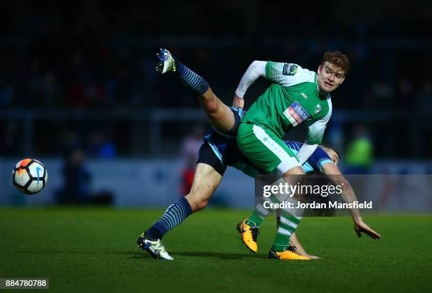 Matt Bloomfield of Wycombe Wanderers challenges Sam Blackman of Letherhead during The Emirates FA Cup Second Round between Wycombe Wanderers and...