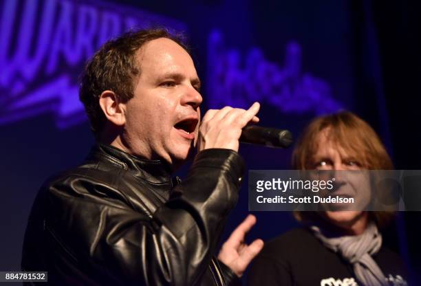 Radio personality Eddie Trunk and bass player Jeff Pilson of Foreigner appear onstage during Frontiers Rock Holiday Bash at The Canyon Club on...