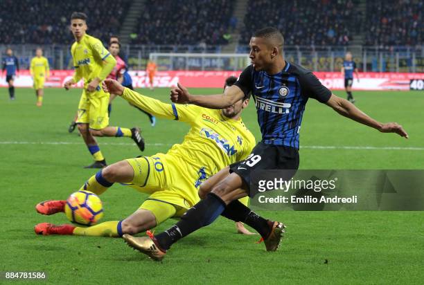 Henrique Dalbert of FC Internazionale Milano is challenged by Nenad Tomovic of AC Chievo Verona during the Serie A match between FC Internazionale...