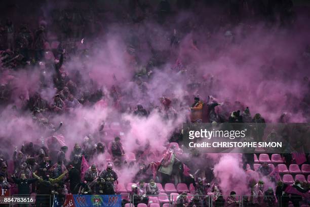 Stade Francais' supporters cheer prior to the French Top 14 Rugby union match between Stade Francais and Racing 92, at the Jean Bouin stadium in...