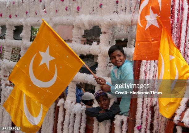 Muslim children hold religious flags as they take part in a procession during Eid Milad-Un-Nabi - the birth anniversary of Prophet Muhammad - the...