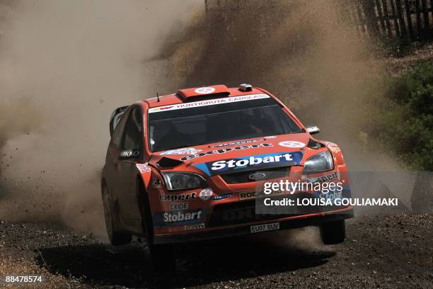 Norwegians Henning Solber and Cato Menkerud drive their Ford Focus RS at Aghii Theodori special stage on the day three of the WRC Rally Acropolis...